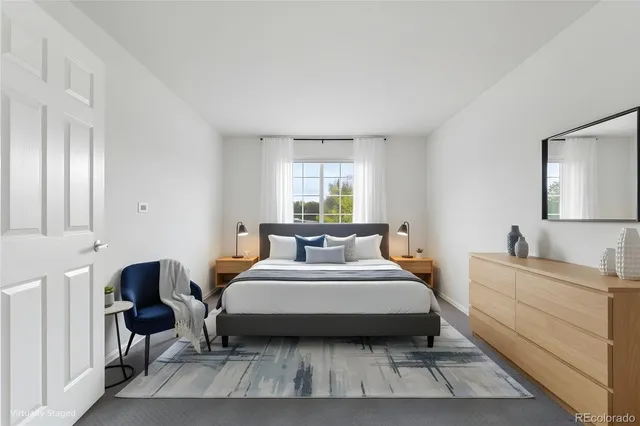 a bedroom with a bed chair and window