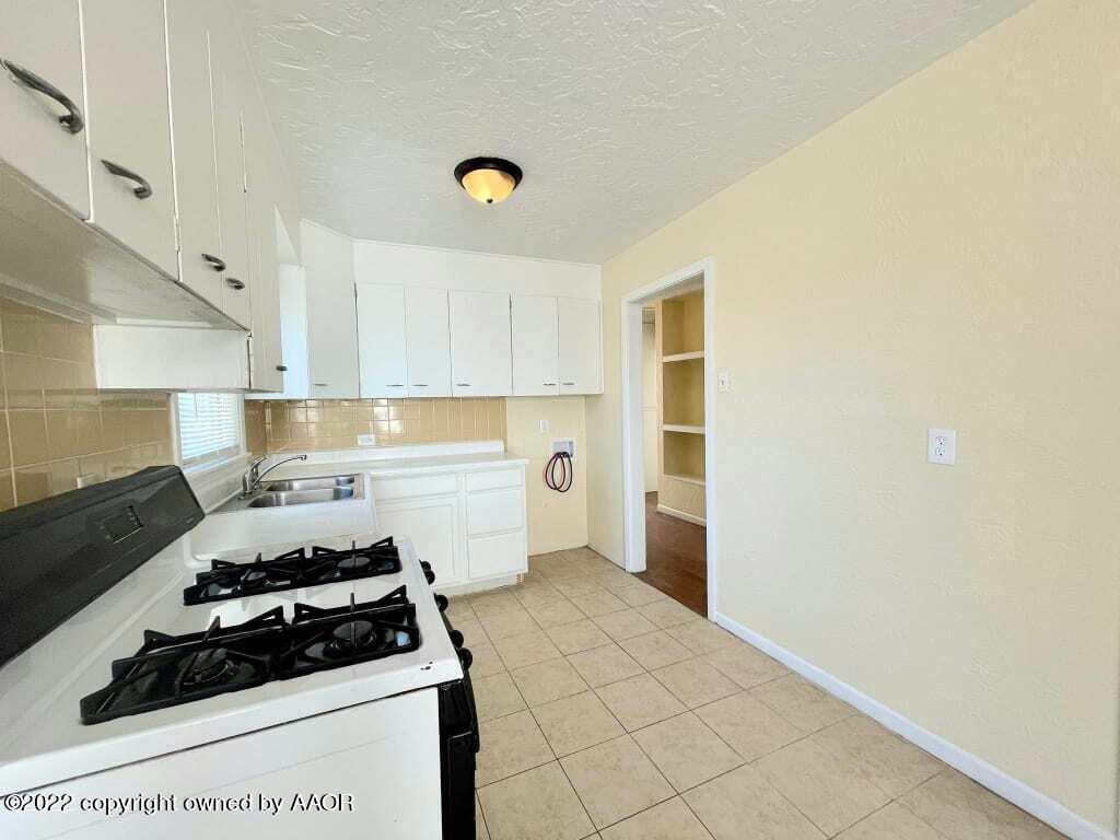 4319 Gables Street Amarillo, TX 79110 - Photo 5 of 15 a kitchen with a stove and a refrigerator