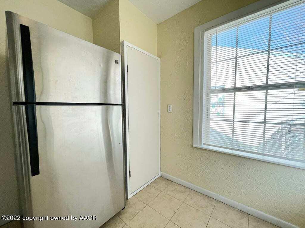 4319 Gables Street Amarillo, TX 79110 - Photo 7 of 15 a white refrigerator freezer and a window
