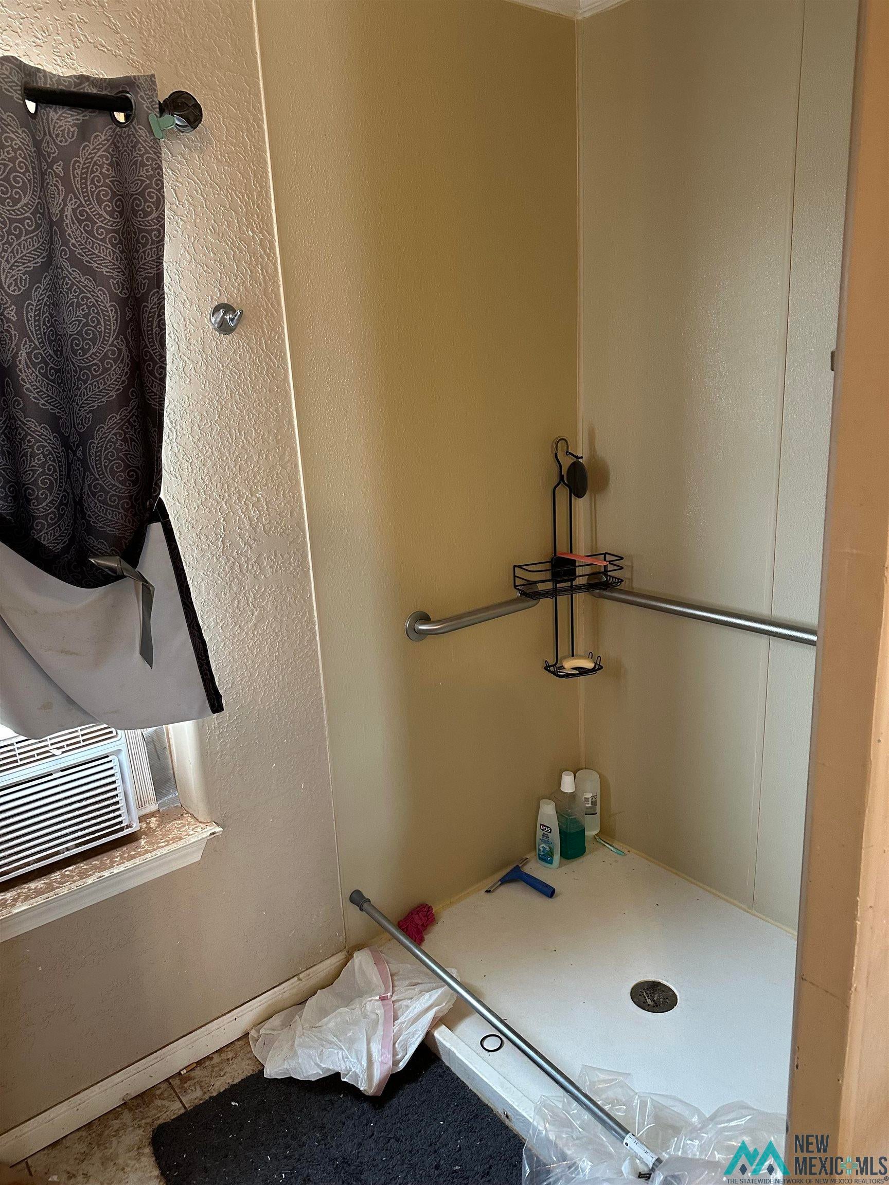 1899 Folsom Road Northwest Deming, NM 88030 - Photo 26 of 76 Bathroom featuring a stall shower and a textured wall