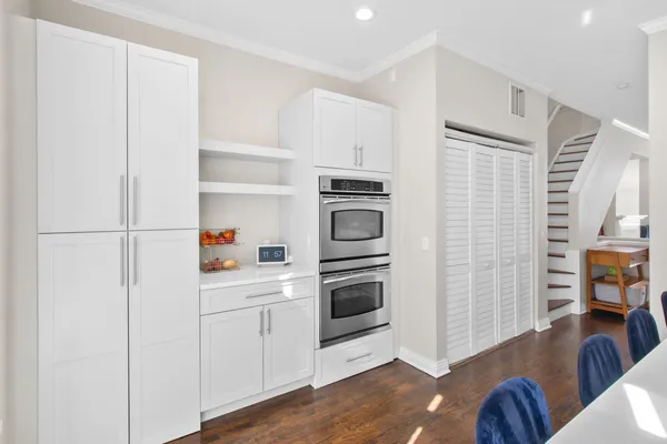 a kitchen with stainless steel appliances a stove a refrigerator and cabinets