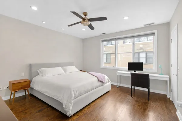 a bedroom with a bed and a desk