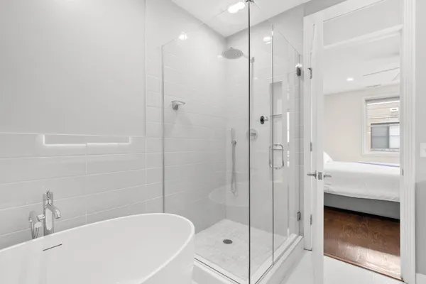 a bathroom with a bathtub and a shower