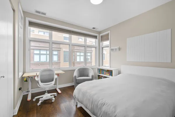 a bedroom with two beds and a large window