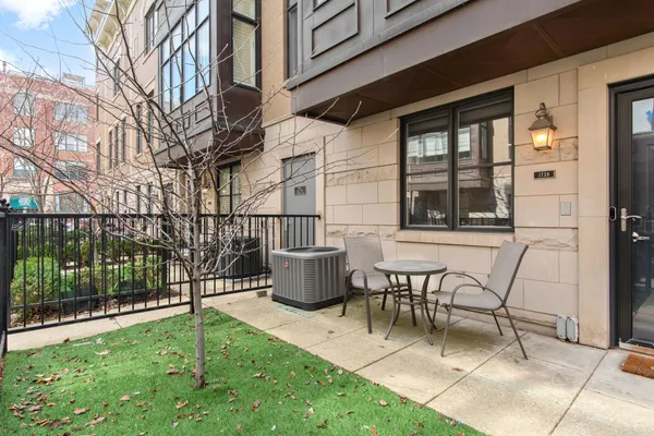 a view of a patio with table and chairs
