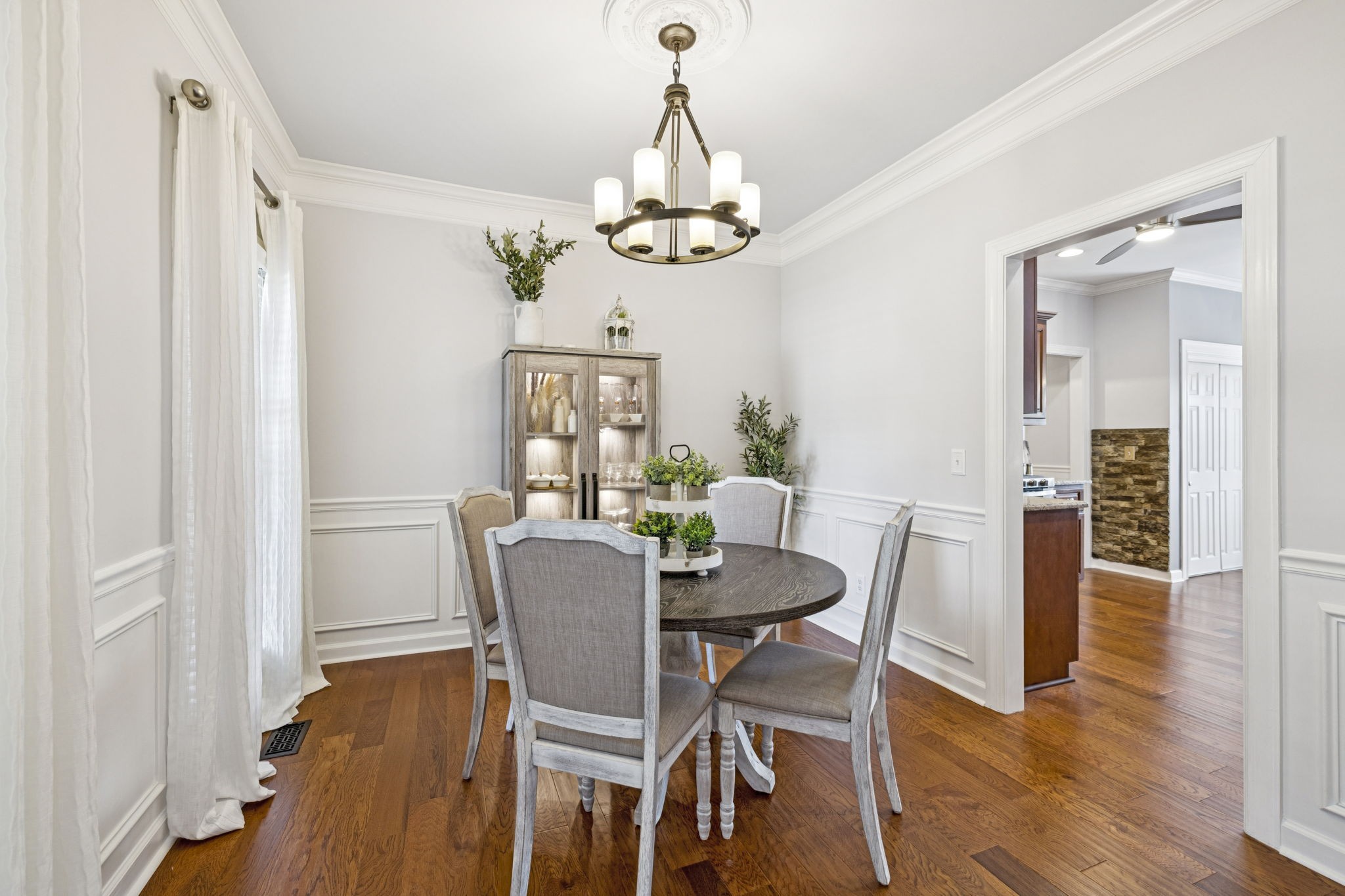 1011 Red Pepper Ridge Spring Hill, TN 37174 - Photo 13 of 76 a dining room with wooden floor a chandelier a wooden table and chairs