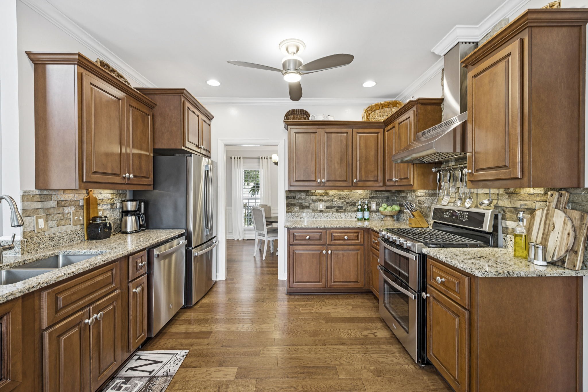 1011 Red Pepper Ridge Spring Hill, TN 37174 - Photo 26 of 76 a kitchen with stainless steel appliances granite countertop a stove top oven a sink dishwasher a refrigerator and cabinets with wooden floor