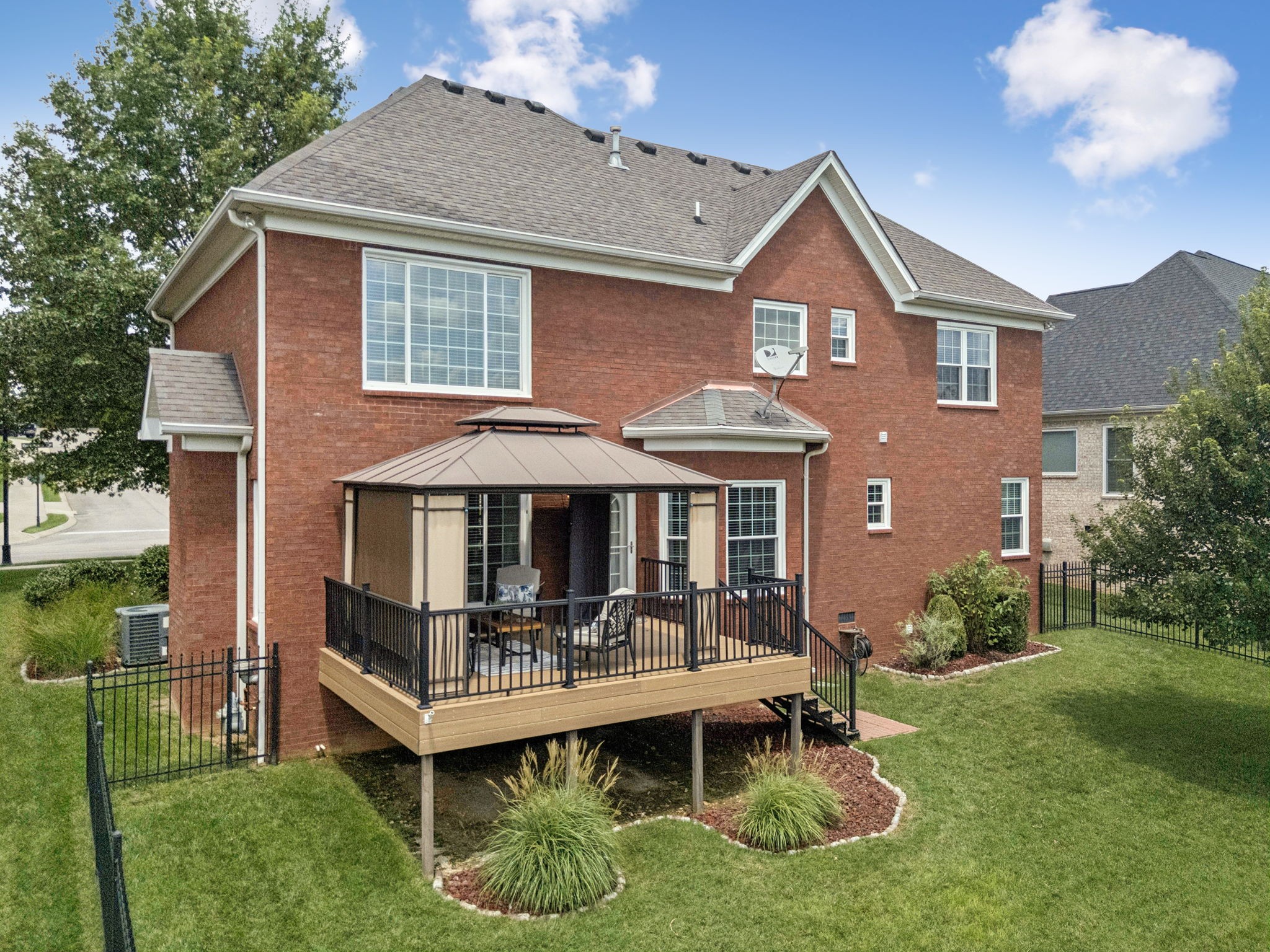 1011 Red Pepper Ridge Spring Hill, TN 37174 - Photo 75 of 76 a front view of a house with a yard table and chairs