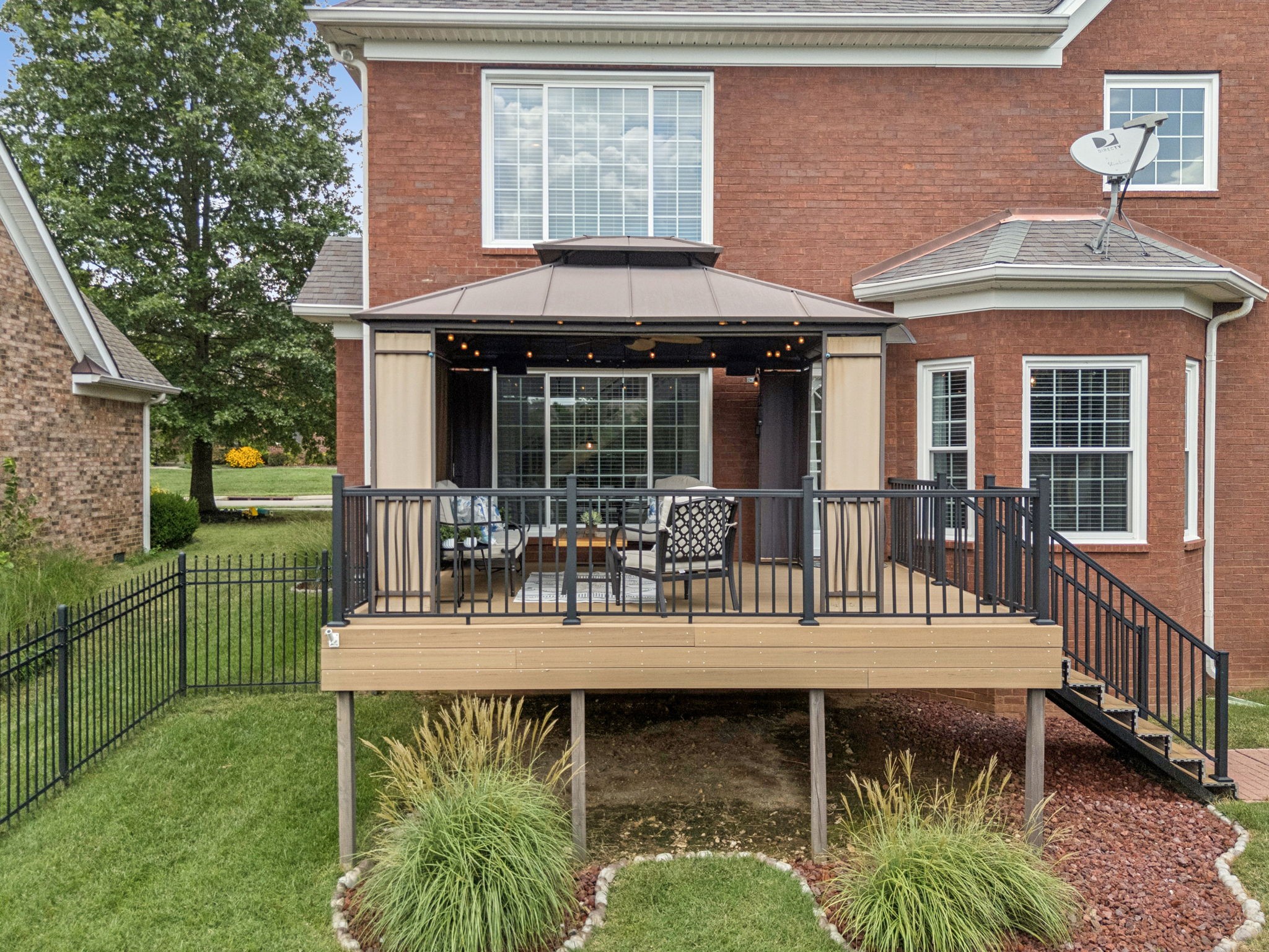 1011 Red Pepper Ridge Spring Hill, TN 37174 - Photo 76 of 76 a view of a house with a wooden deck and a floor to ceiling window