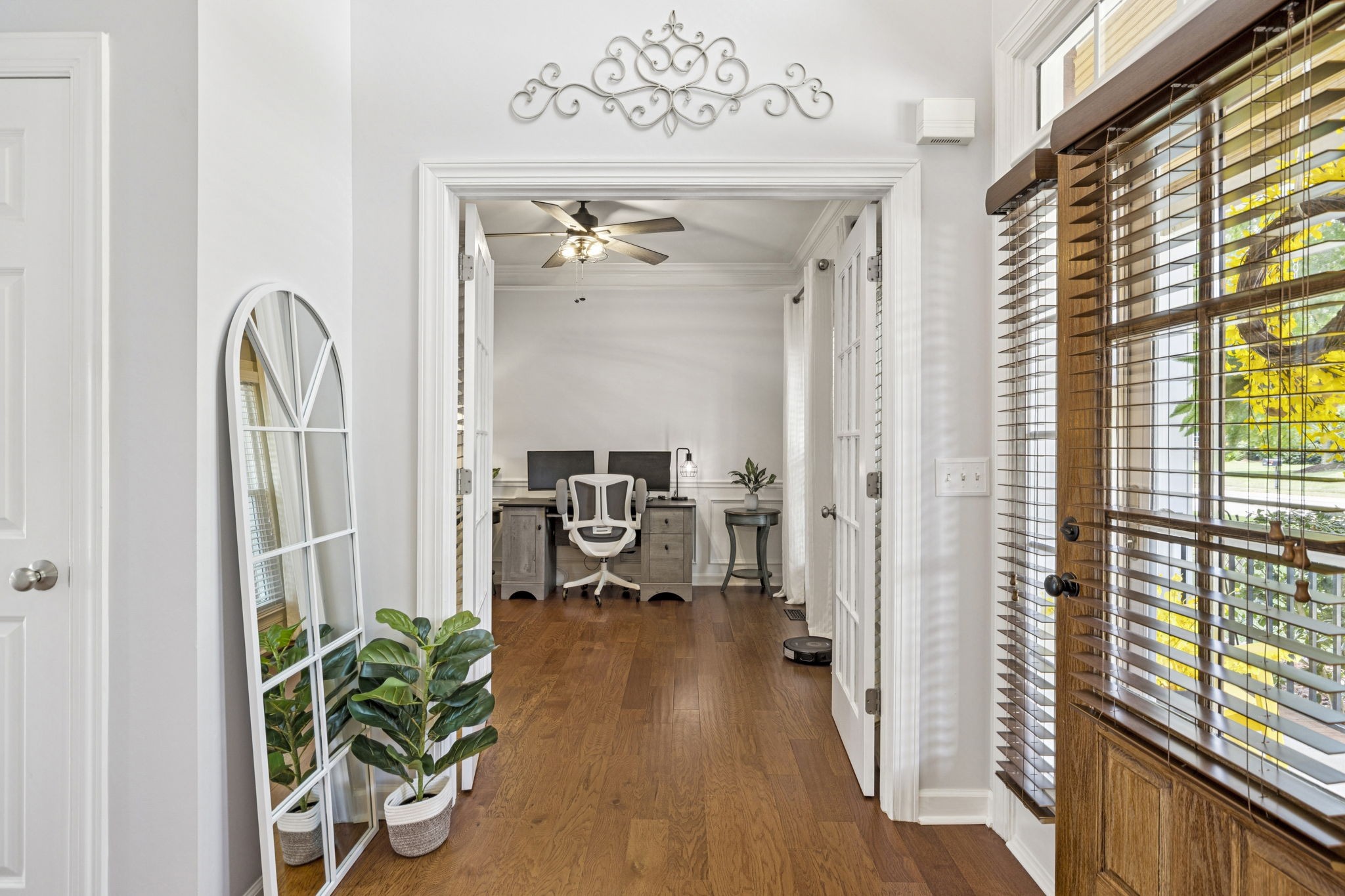 1011 Red Pepper Ridge Spring Hill, TN 37174 - Photo 8 of 76 a view of a hallway with wooden floor and a potted plant