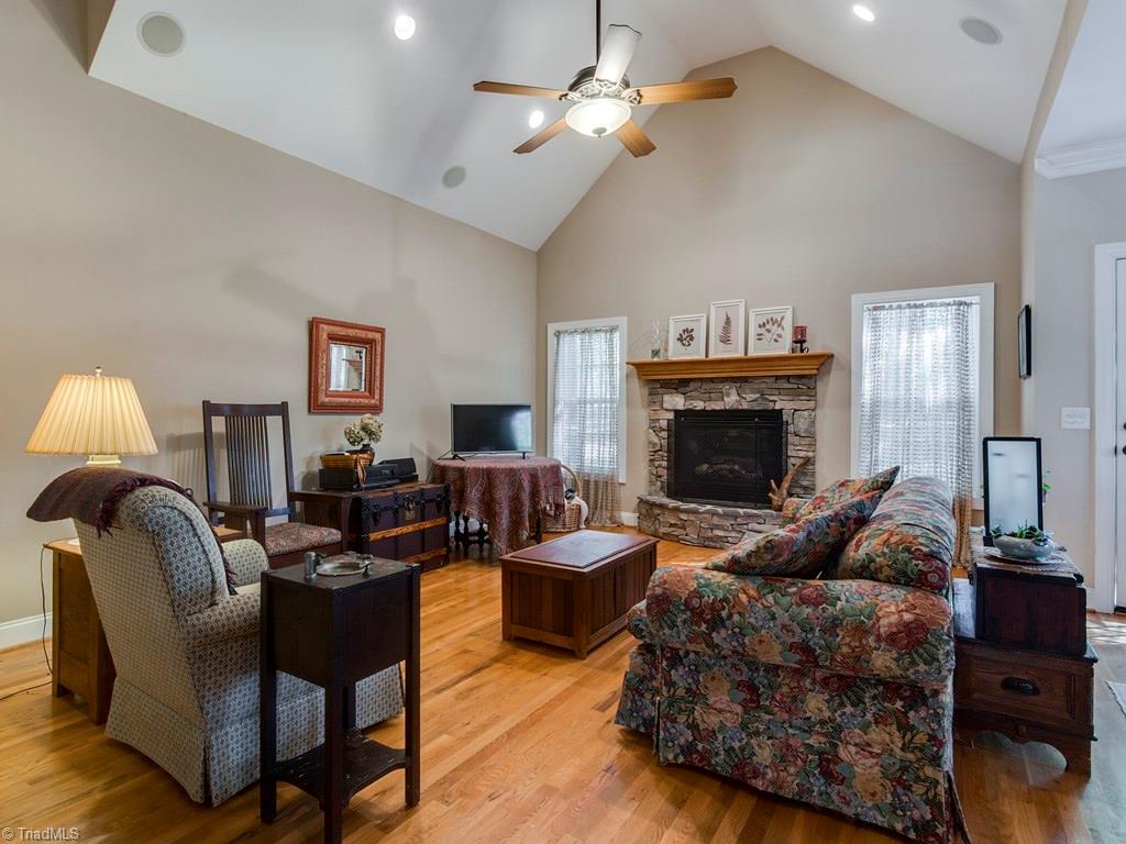 7070 Lanier Road Summerfield, NC 27358 - Photo 11 of 27 Fireside Great Room with stone surround and French Door leading to the rear Deck