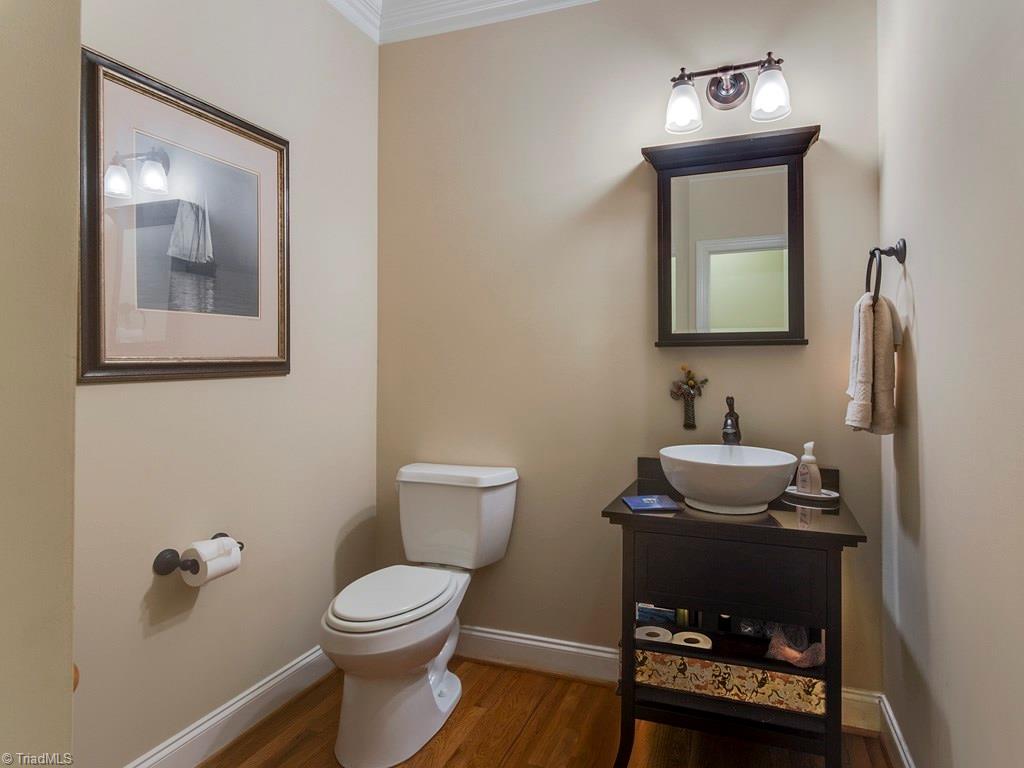 7070 Lanier Road Summerfield, NC 27358 - Photo 12 of 27 Main level Half Bathroom with stone topped vanity with raised basin