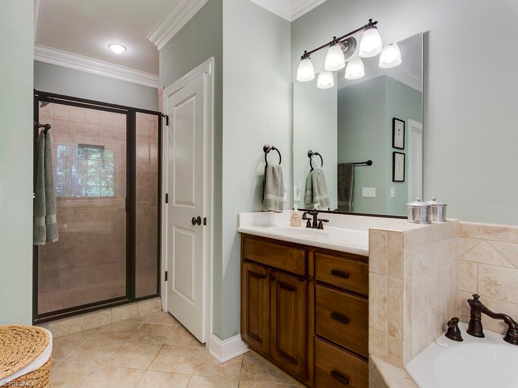 7070 Lanier Road Summerfield, NC 27358 - Photo 17 of 27 Fully tiled, oversized shower enjoys surround sound. The walk-in closet is around the corner.