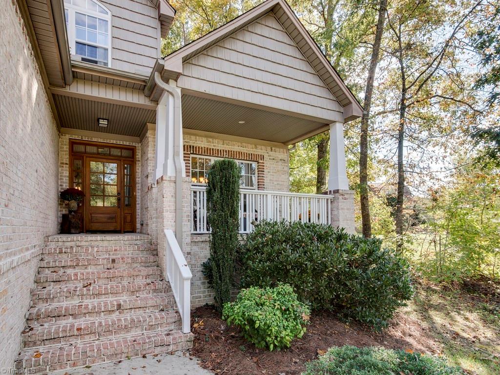 7070 Lanier Road Summerfield, NC 27358 - Photo 4 of 27 Open Front Porch with Craftsman-inspired tapered columns and beaded board ceiling.