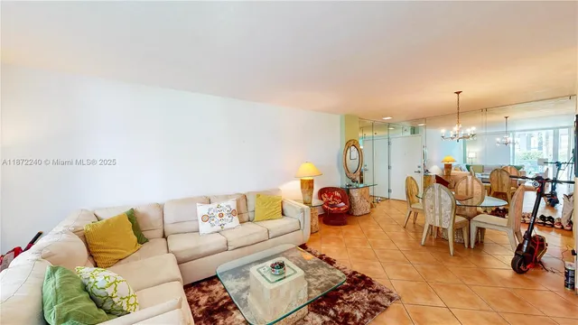 a view of a dining room with furniture and a chandelier