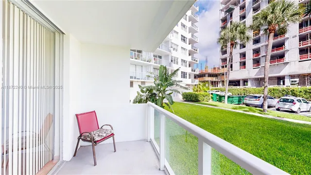 a view of a swimming pool with a lounge chairs in front of a house