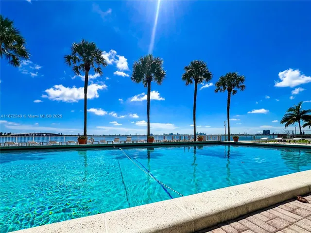 a view of a chairs and table in the city view