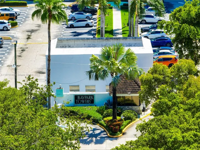 a view of building with lot of windows and trees