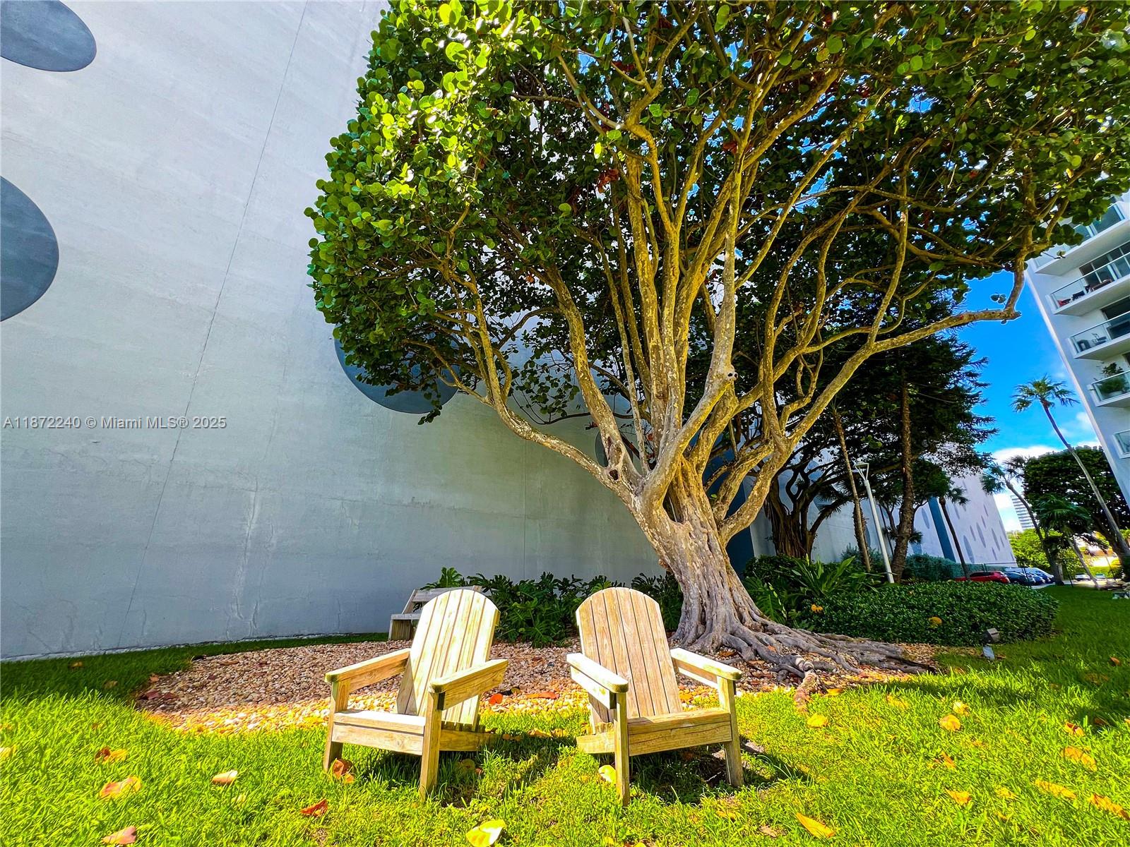 3301 Northeast 5th Avenue, Unit 110 Miami, FL 33137 - Photo 64 of 87 a backyard of a house with table and chairs