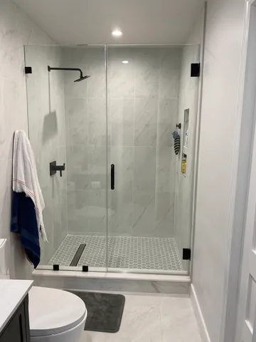 a bathroom with a toilet a sink and shower
