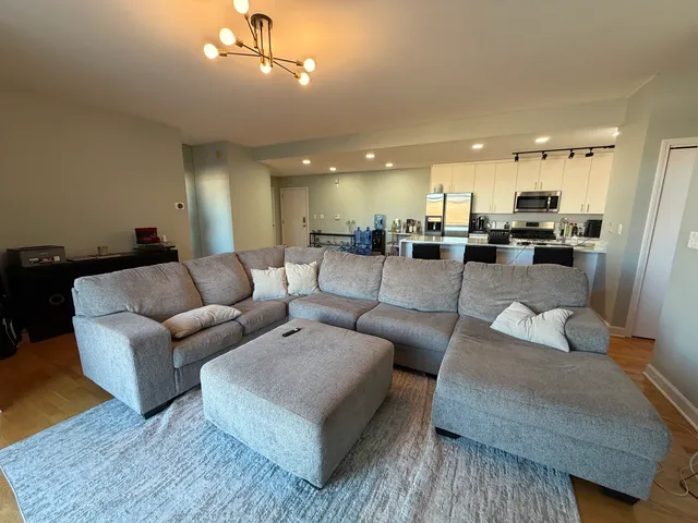 a living room with furniture and a chandelier