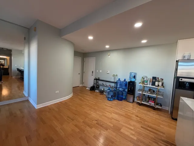 a view of a room with furniture and wooden floor
