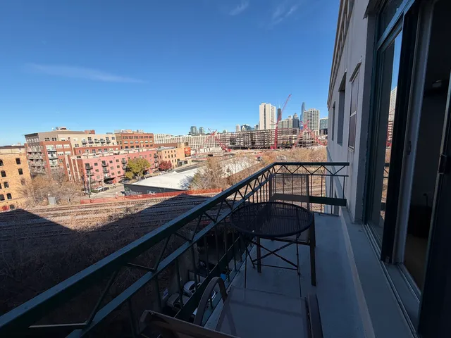 a view of a chairs and table in a balcony