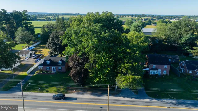 a backyard of a house with barbeque oven and outdoor seating