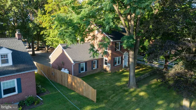 a view of a patio with table and chairs with wooden floor and fence