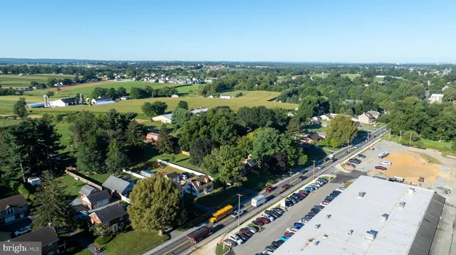 a view of a house with a tree next to a yard