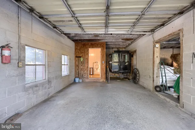 a view of a house with a yard and large tree