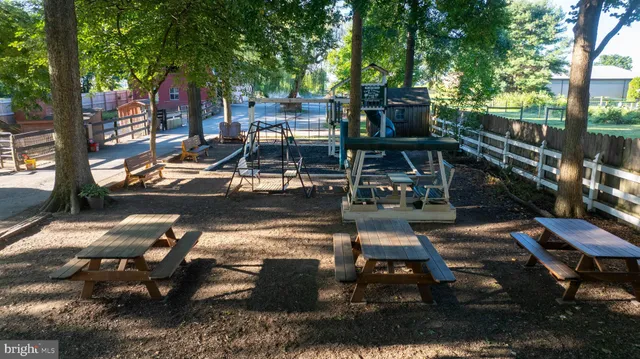 a view of a house with backyard water fountain and sitting area