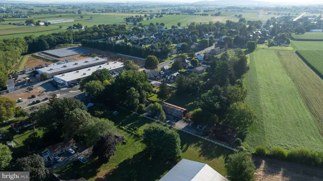 an aerial view of a house with a garden and lake view