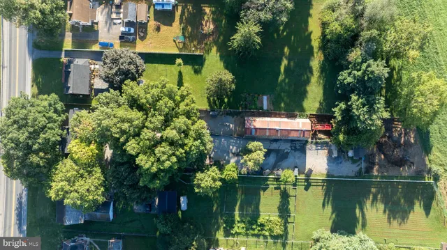 an aerial view of a house with a garden and lake view