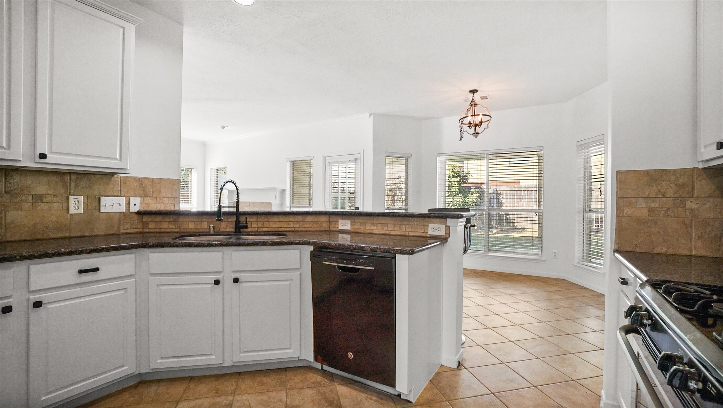 810 Flanners Court Spring, TX 77373 - Photo 16 of 45 a kitchen with stainless steel appliances granite countertop a stove a sink and a microwave