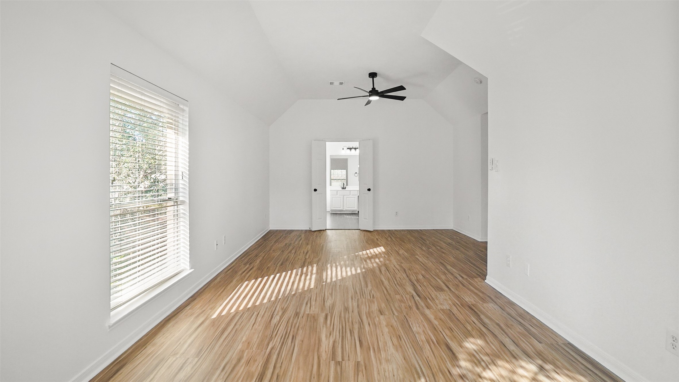 810 Flanners Court Spring, TX 77373 - Photo 27 of 45 a view of an empty room with wooden floor and a window