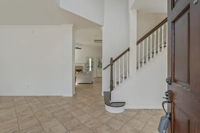 a view of a hallway with windows and stairs