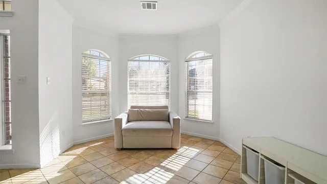 a living room with furniture and a floor to ceiling window