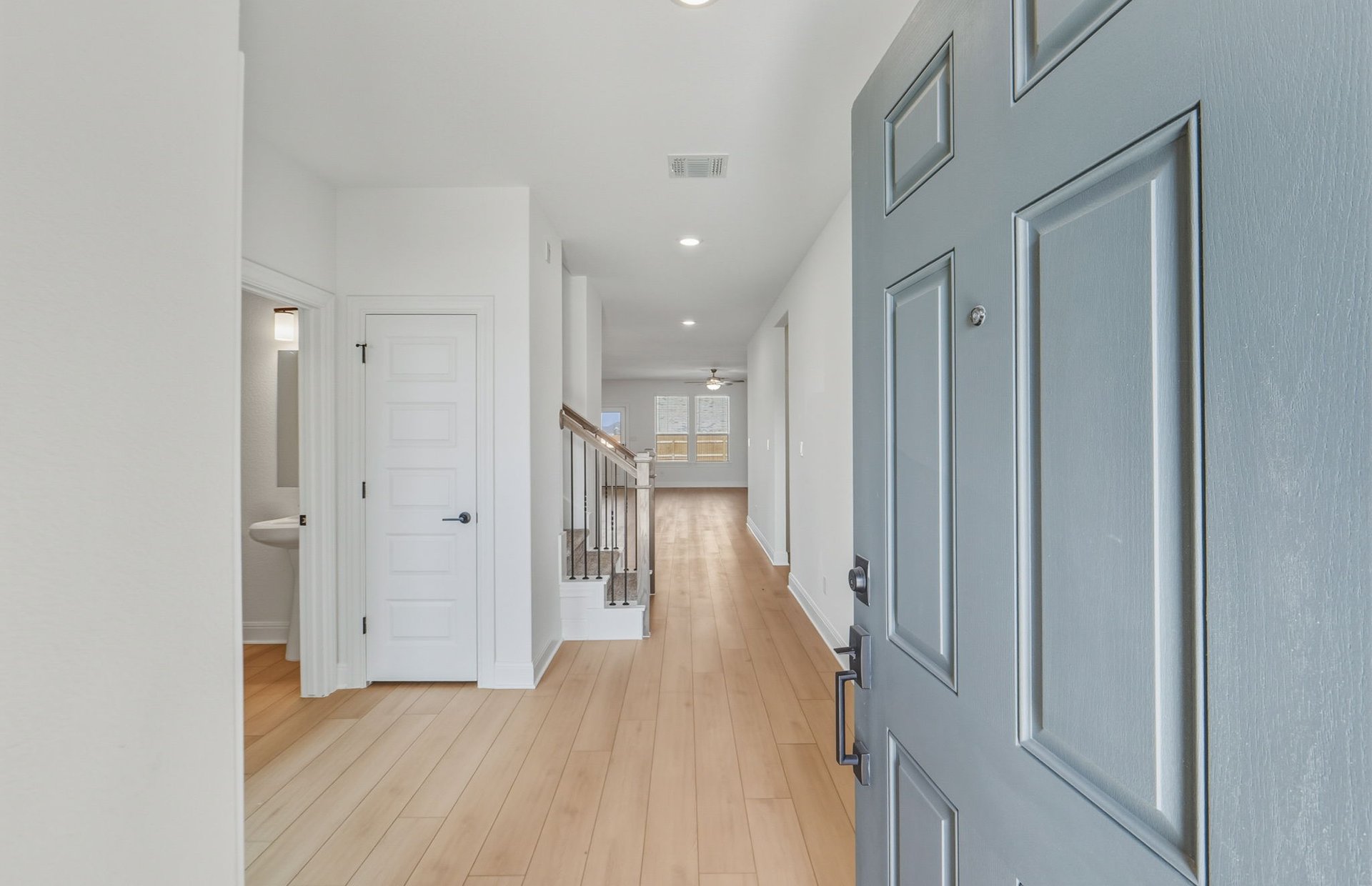 16800 Catemaco Walk Manor Manor, TX 78653 - Photo 21 of 26 a view of a hallway with wooden floor and staircase