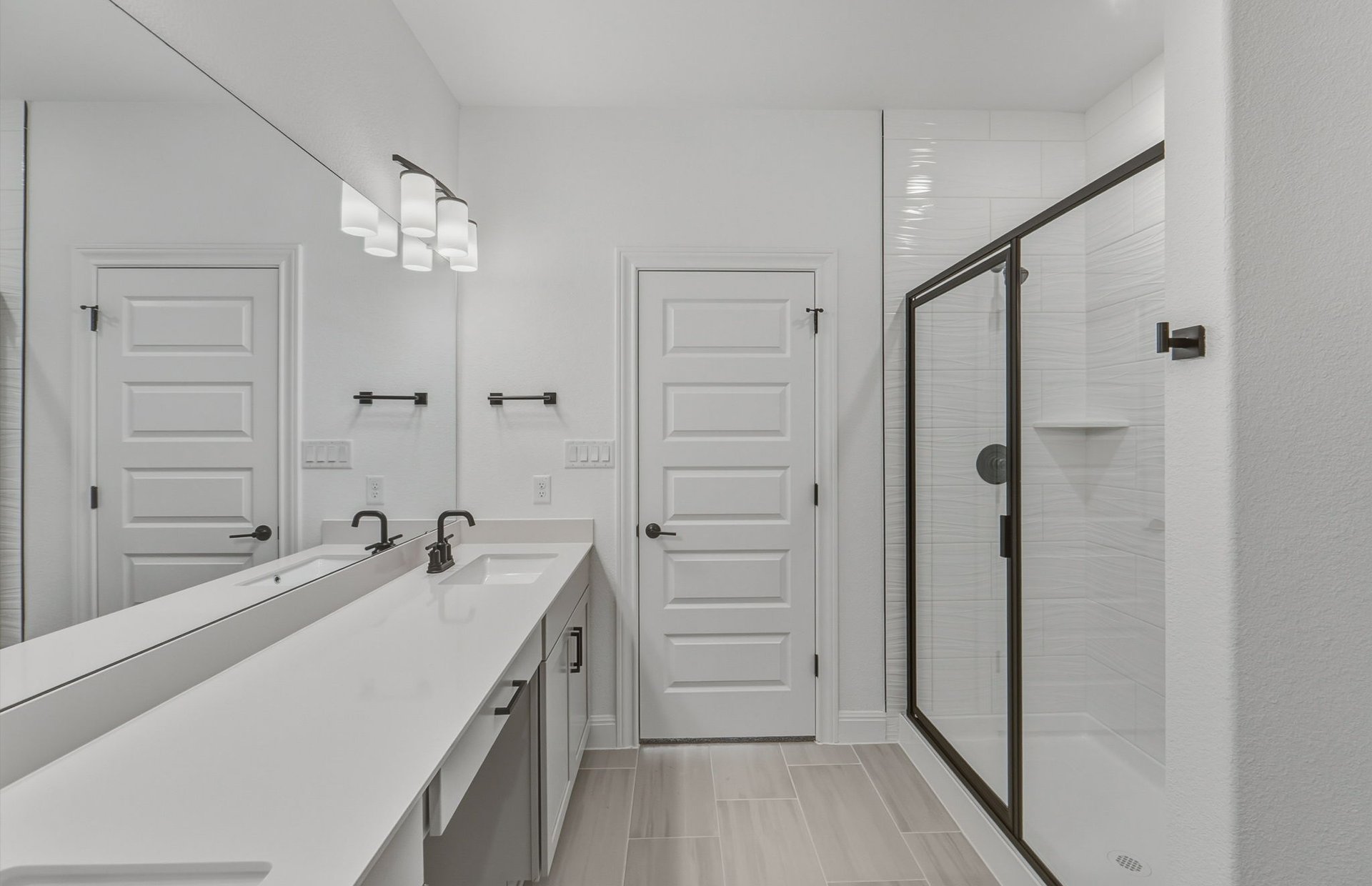 16800 Catemaco Walk Manor Manor, TX 78653 - Photo 8 of 26 a bathroom with a double vanity sink a mirror and a bathtub