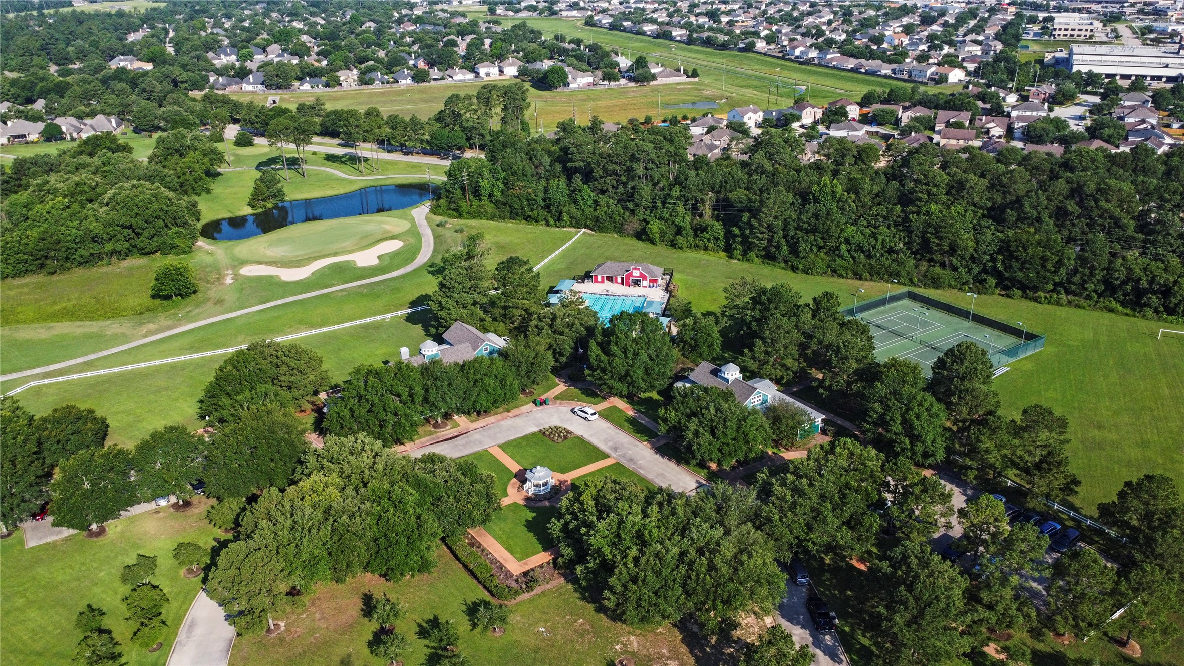 20722 Windrose Bend Drive Spring, TX 77379 - Photo 43 of 50 An aerial view of the two clubhouses, lap pool, tennis courts, and hole #16 of the Windrose Golf Course.