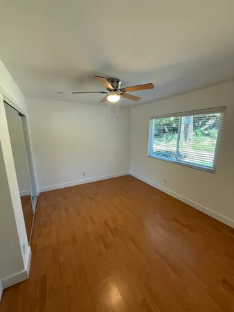 a view of a livingroom with a ceiling fan and window
