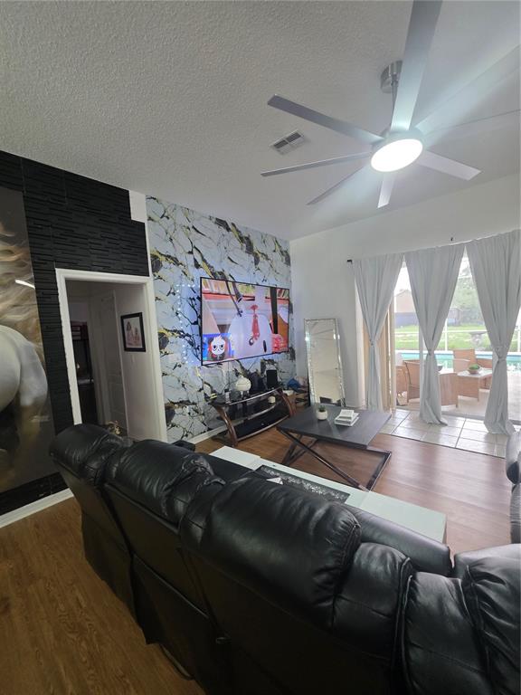17820 Monteverde Drive Spring Hill, FL 34610 - Photo 25 of 42 a living room with furniture and a flat screen tv