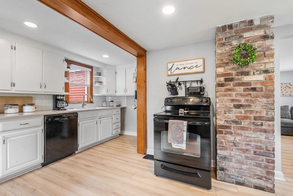 66 Bethany Road Framingham, MA 01702 - Photo 9 of 20 a kitchen with stainless steel appliances granite countertop a stove a sink and a microwave