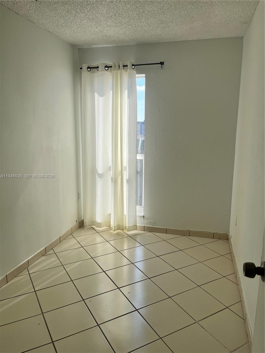 6780 West 2nd Court, Unit 408 Hialeah, FL 33012 - Photo 15 of 15 a view of an empty room and a window