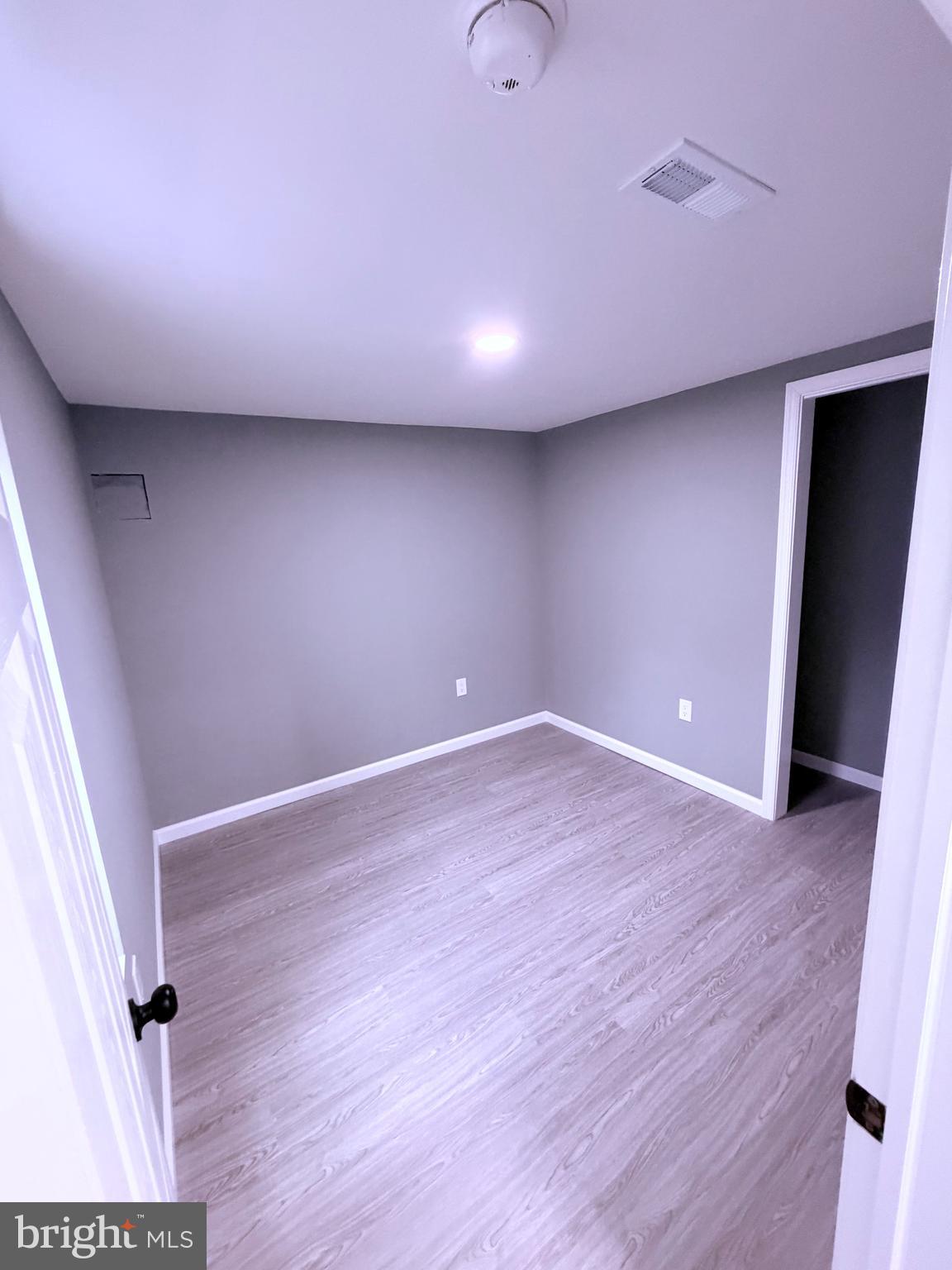 3507 Riviera Street Temple Hills, MD 20748 - Photo 11 of 16 an empty room with wooden floor and entrance