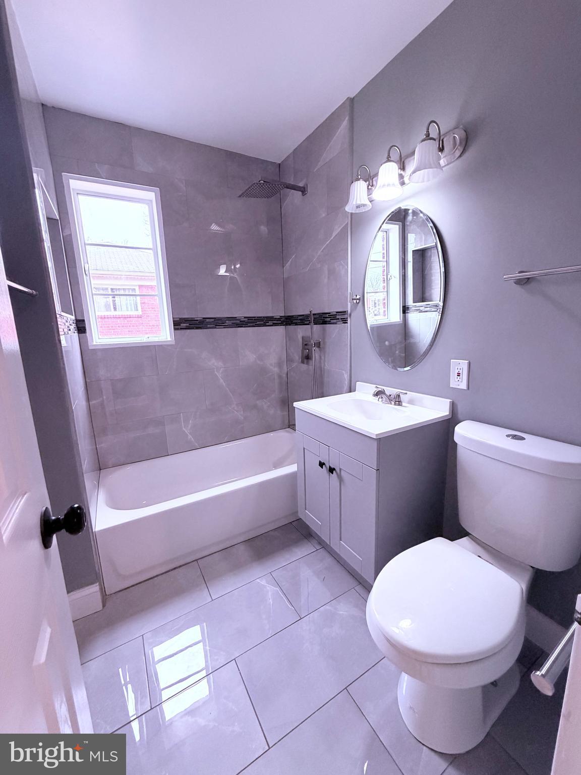 3507 Riviera Street Temple Hills, MD 20748 - Photo 7 of 16 a bathroom with a sink a toilet a mirror and bathtub