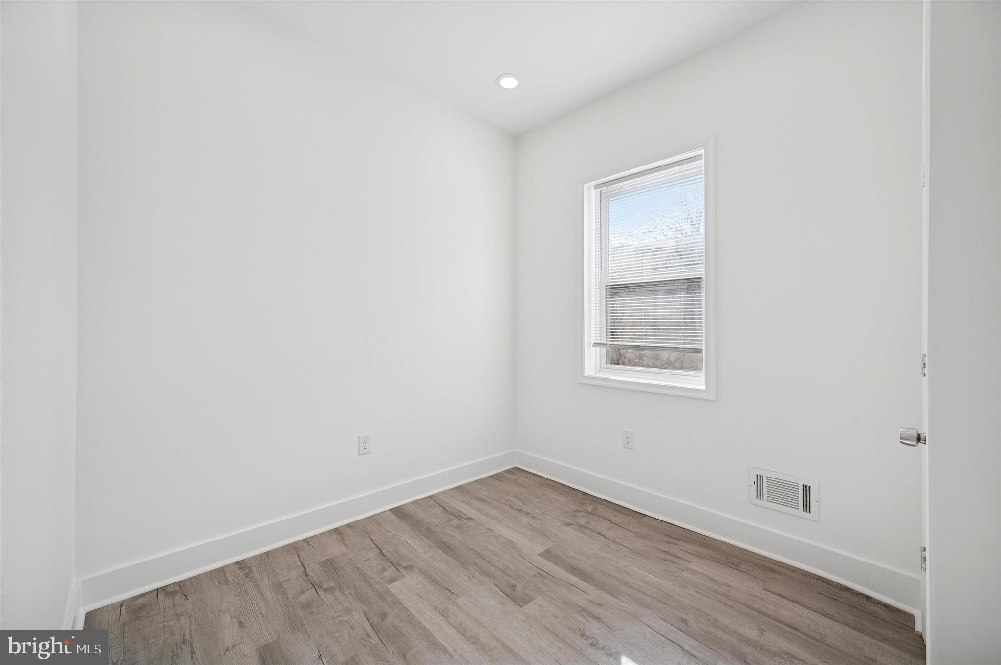 2135 North 20th Street Philadelphia, PA 19121 - Photo 13 of 20 a view of an empty room with wooden floor and a window