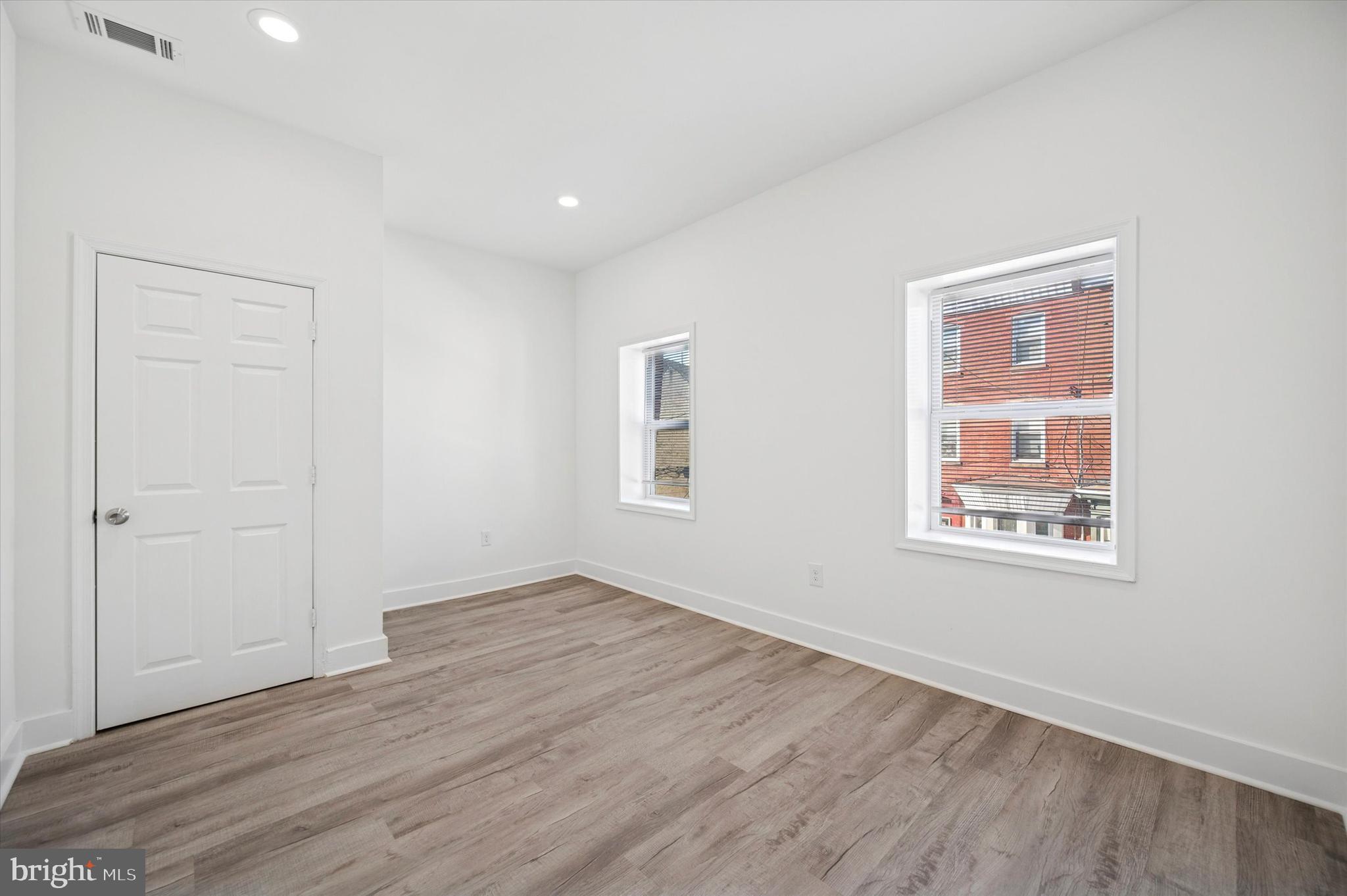 2135 North 20th Street Philadelphia, PA 19121 - Photo 15 of 20 an empty room with wooden floor and windows