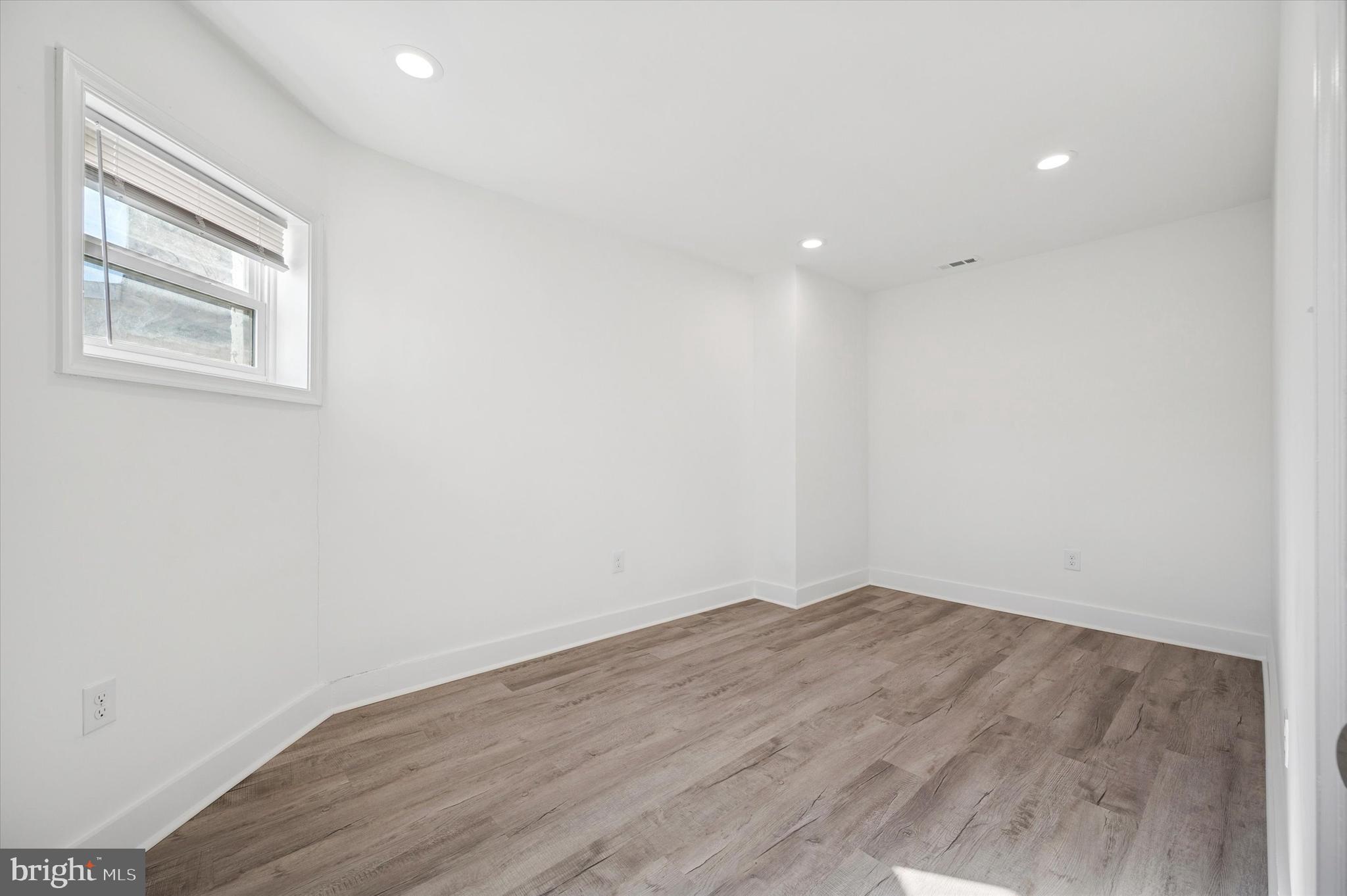 2135 North 20th Street Philadelphia, PA 19121 - Photo 16 of 20 an empty room with wooden floor and windows